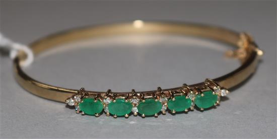 A 9ct gold, emerald and diamond hinged bangle,